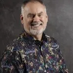 Smiling, older, male patient wearing a floral button up