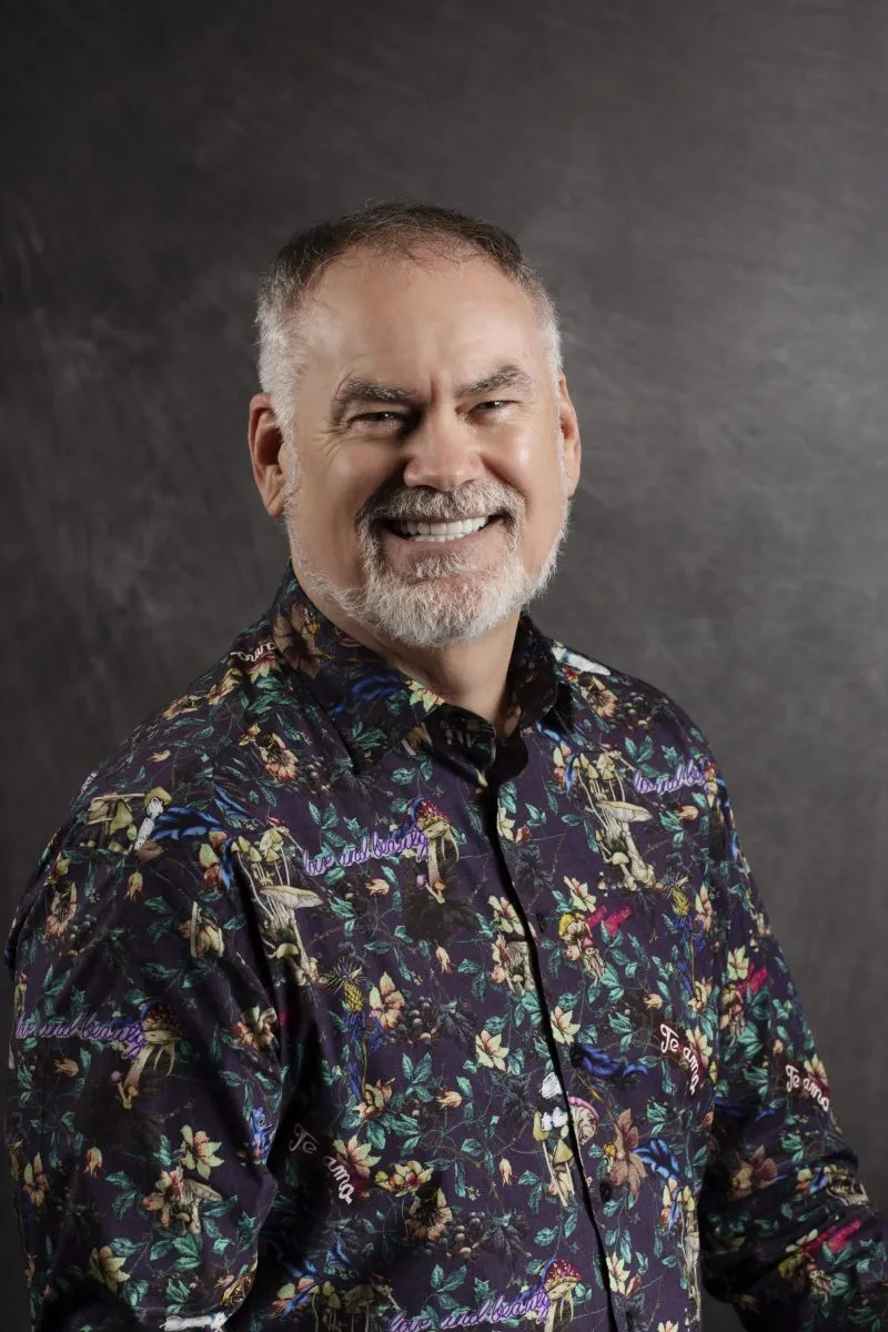 Smiling, older, male patient wearing a floral button up