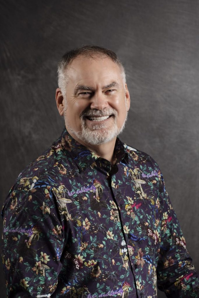 Smiling, older, male patient wearing a floral button up