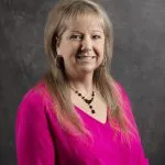 Smiling, female patient wearing pink