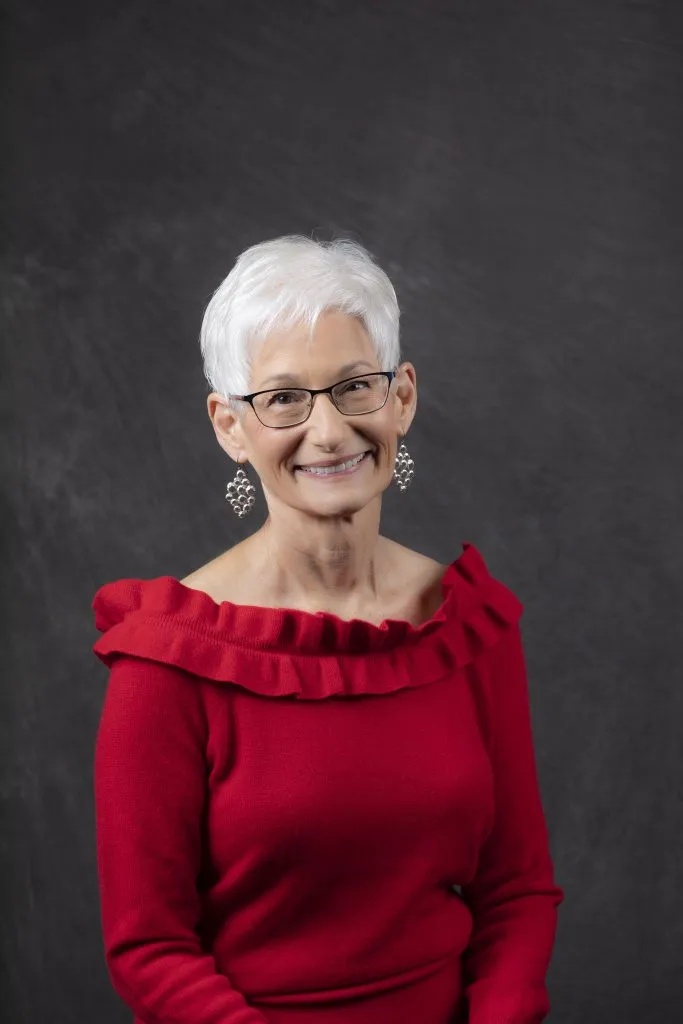 Smiling, older, female patient wearing red