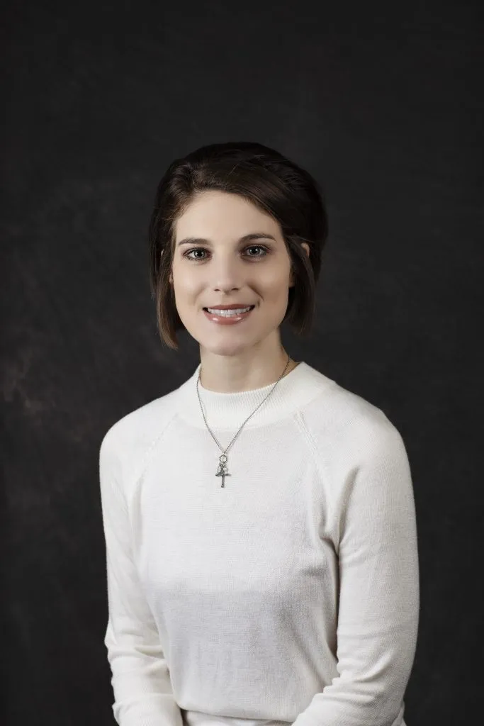 Smiling, young, female patient wearing white