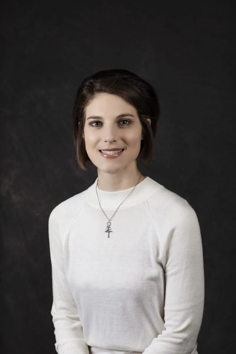 Smiling, young, female patient wearing white
