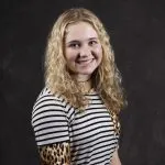 Smiling, young, female patient wearing black & white stripes