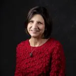 Smiling, female patient wearing a red sweater