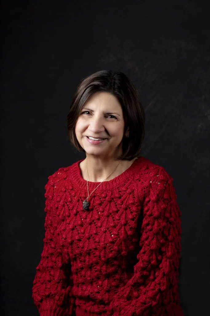 Smiling, female patient wearing a red sweater