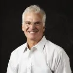 Smiling, older, male patient wearing a white button up