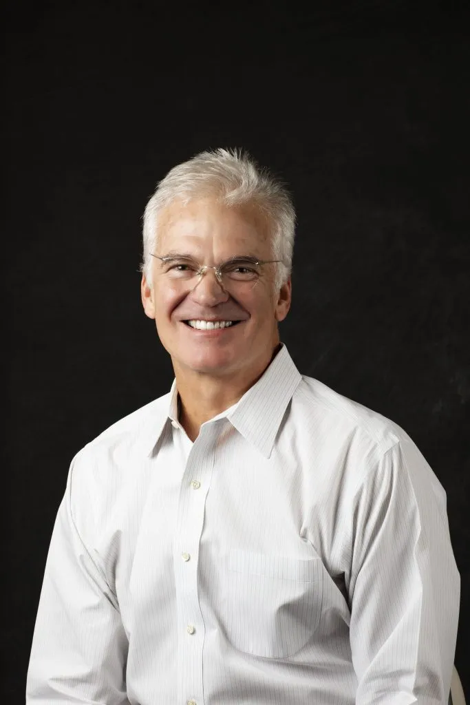 Smiling, older, male patient wearing a white button up