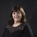 Smiling, female patient wearing black & lace shirt