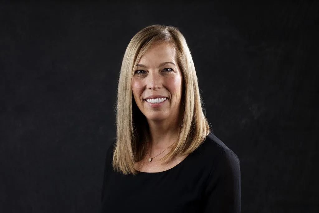 Smiling, female patient wearing a black shirt