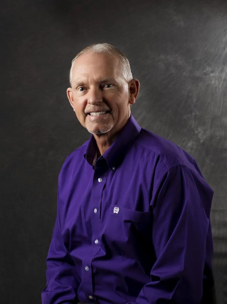 Smiling, older, male patient wearing a navy blue button up