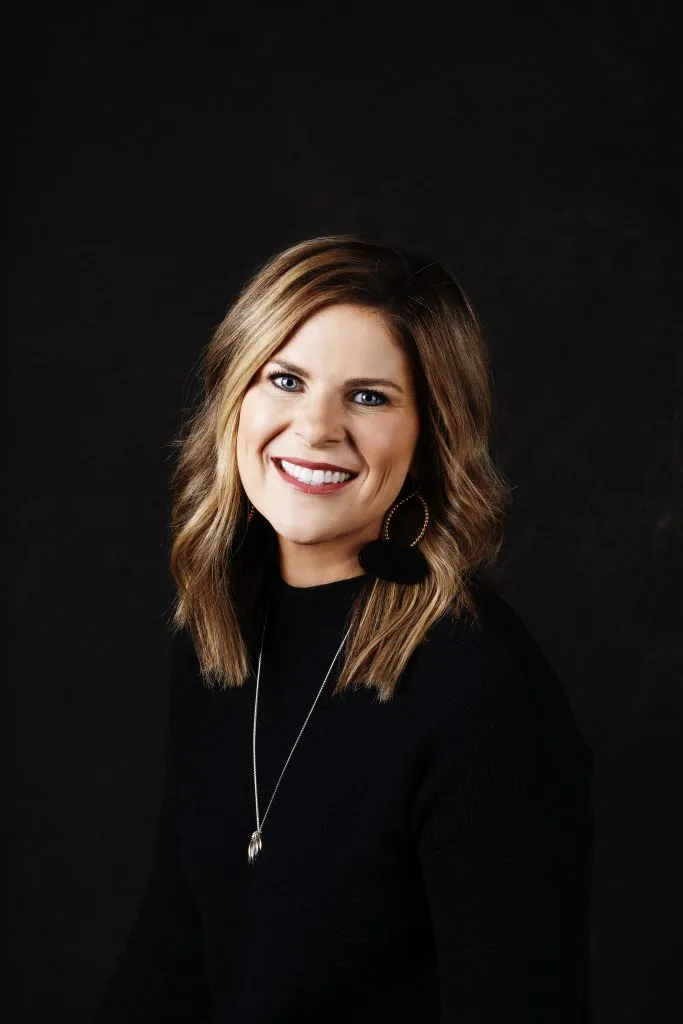 Smiling, female patient wearing black